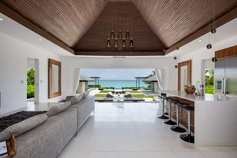 Fully retractable wall of glass facing the ocean.