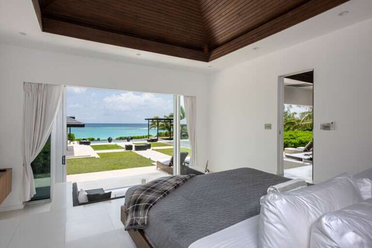 North master suite has a wall of glass with a sweeping view of the ocean.