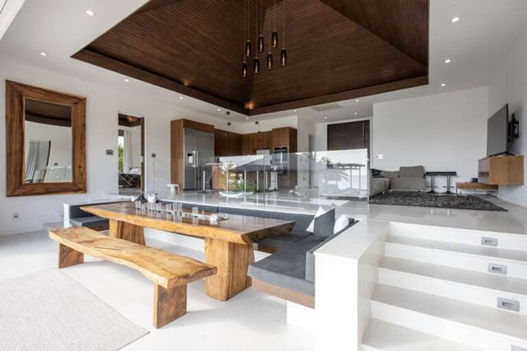 Overlooking the grounds & ocean is a sunken large dining area with an enormous teak dining table imported from Bali.