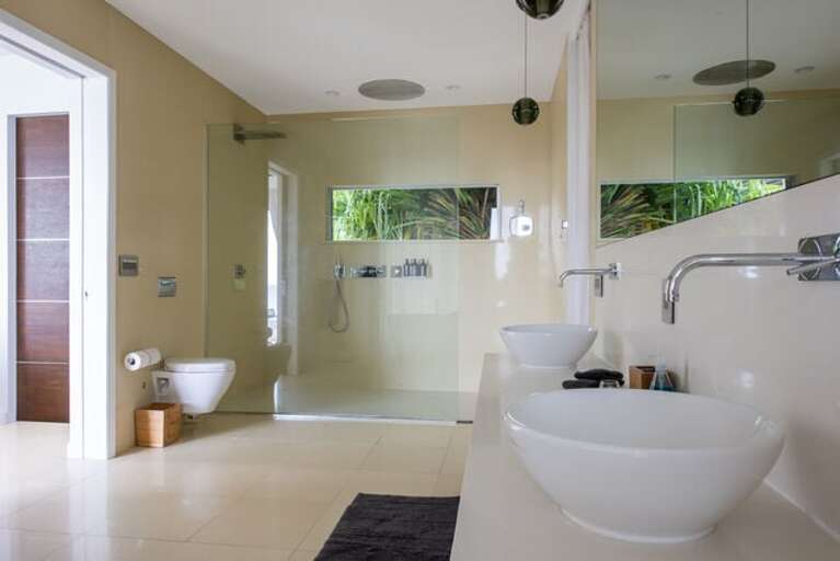 Ultra-luxury master bath with Caesar stone walls and floors, top of the line luxury Hansgrohe Axor fixtures, and solid marble stand-alone tubs.