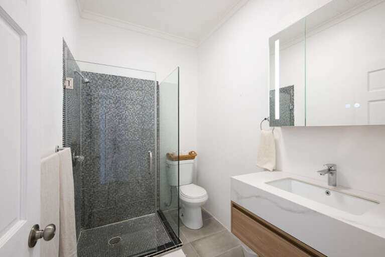 Bath with walk in shower.