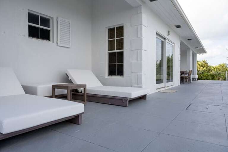 Beachfront patio, furnished for both dining and lounging. Beachfront patio, furnished for both dining and lounging.