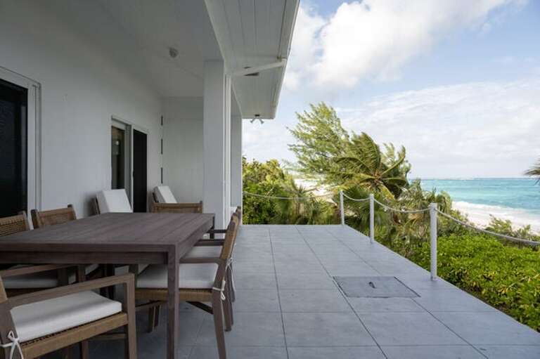 Beachfront patio, furnished for both dining and lounging. Beachfront patio, furnished for both dining and lounging.
