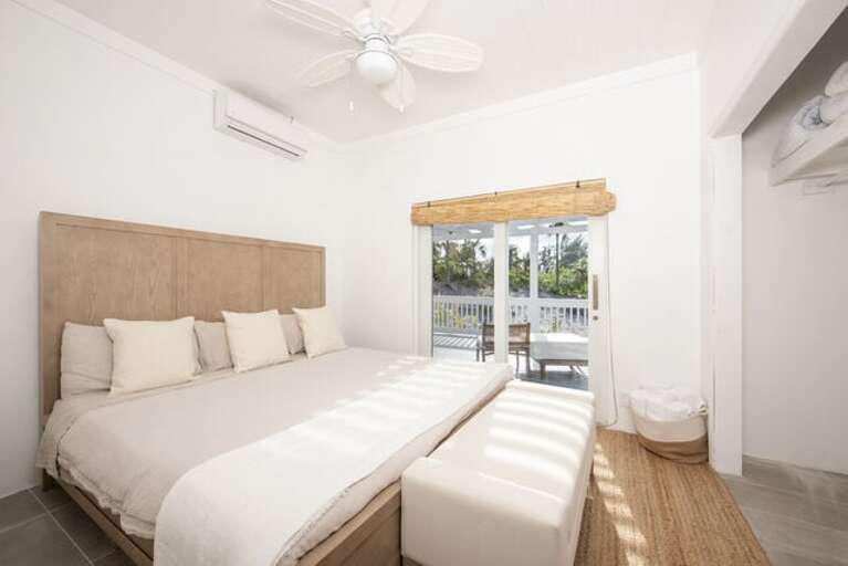 Bedroom Four with king bed, garden view, and sliding door to the patio. Bedroom Four with king bed, garden view, and sliding door to the patio.