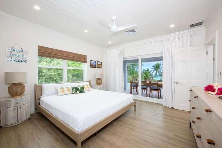 Guest bedroom with King bed, beautiful en-suite bathroom featuring walk-in showers.
