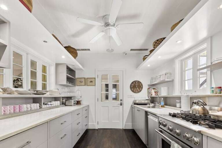 Fully equipped with top-of-the-line Elextrolux Icon appliances including a built-in column refrigerator-freezer, gas range, dishwasher, and many small appliances.