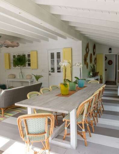 The outdoor area is the gathering place for afternoon lunch with an outdoor kitchen and 14-person dining table.