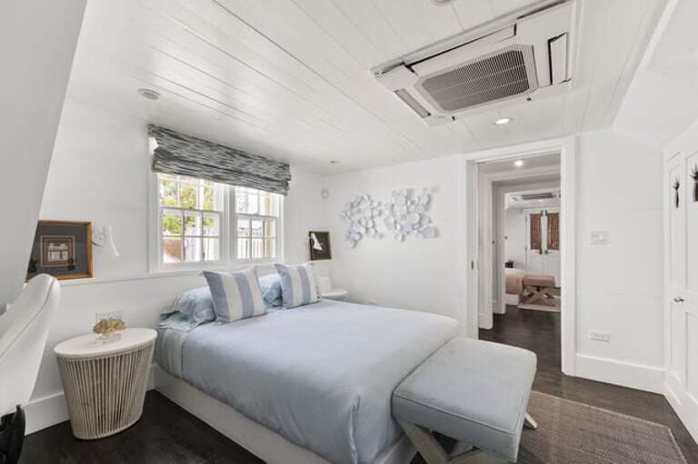 Second upstairs bedroom with queen bed, en-suite bathroom and private balcony.