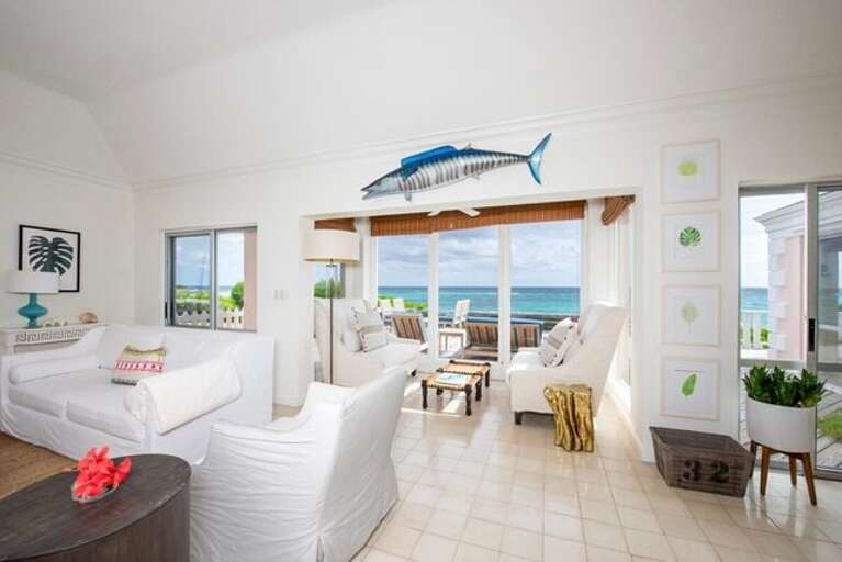 Open-plan living space that is tastefully decorated with island-inspired accents Open-plan living space that is tastefully decorated with island-inspired accents