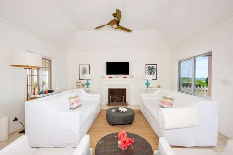 The spacious living room features comfortable seating and a large flat-screen TV