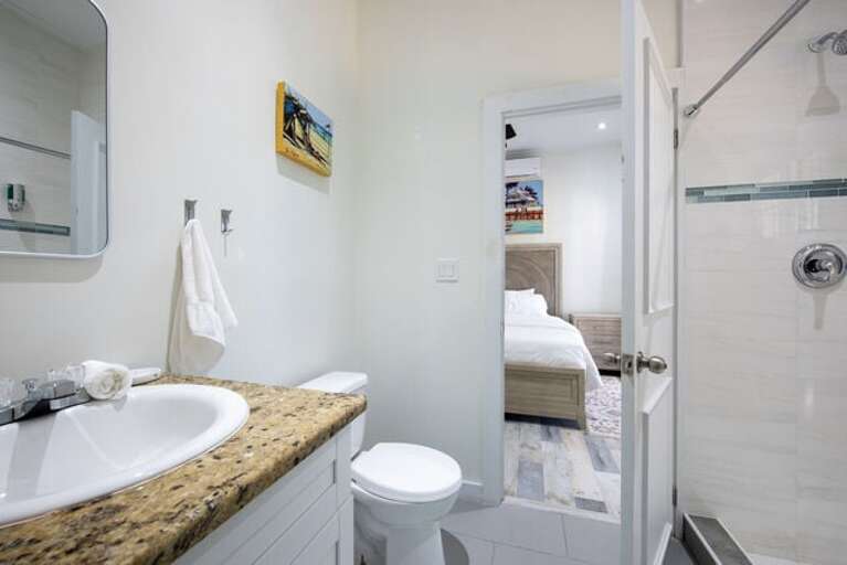 Jack-and-jill guest bath with walk-in shower. Jack-and-jill guest bath with walk-in shower.