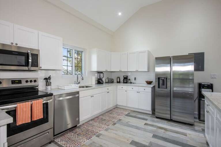 The kitchen boasts all stainless-steel appliances and quartz countertops with additional bar seating.