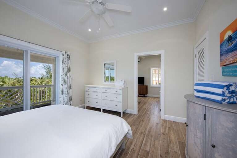 Simple Life Cottage bedroom with king bed and slider to the veranda.