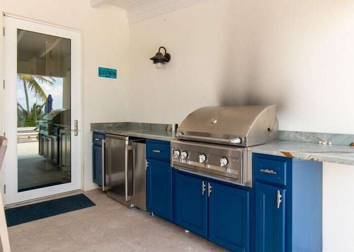 Outdoor kitchen with a gas grill.