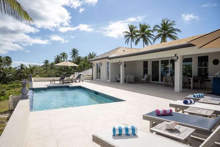 The pool patio is furnished for lounging and dining.