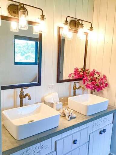 Bath with double sinks and walk-in shower.