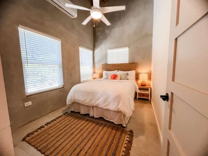 The second bedroom features a queen bed and shares a bathroom with the bunk room.