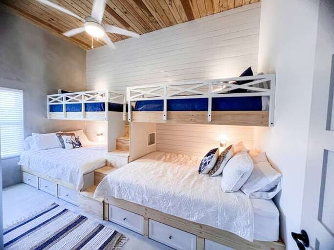 The kids bedroom features two custom-built twin-over-queen bunk beds, fitted with reading lights, which can sleep up to six guests.