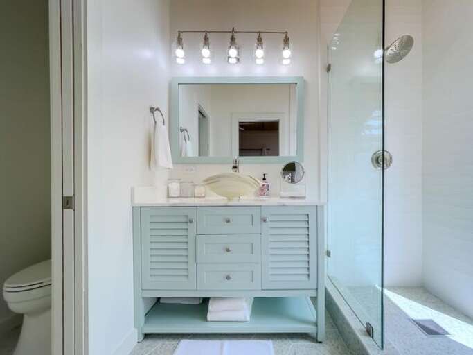 Bath with walk-in shower.