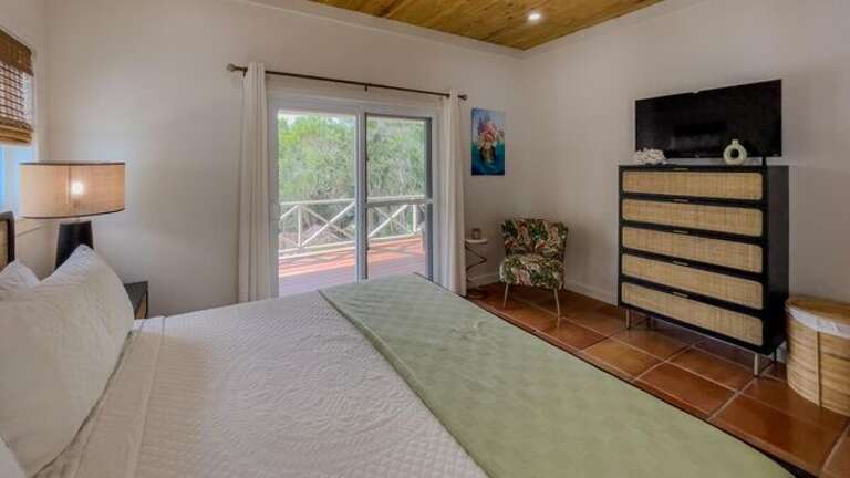 The master bath steps out onto a private enclosed deck.