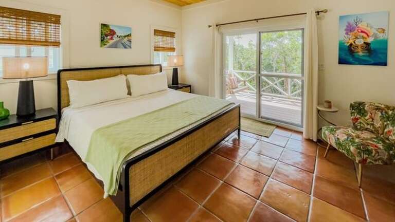 The master bedroom is furnished with a king bed and has a full en-suite bath with walk-in shower.