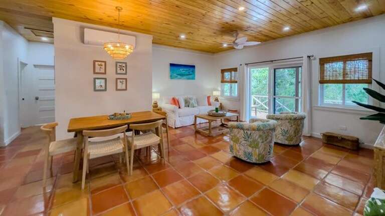 Professionally decorated home features a large open-plan great room.  The dining area has seating for six, plus four seats at the kitchen island.