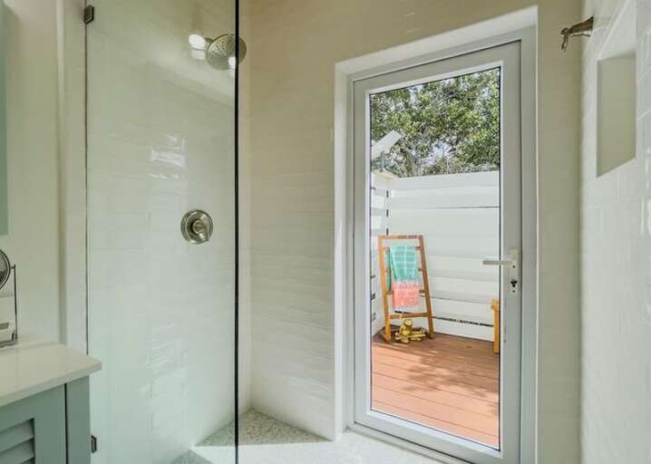 Walk in shower with a spectacular outdoor copper soaking tub.