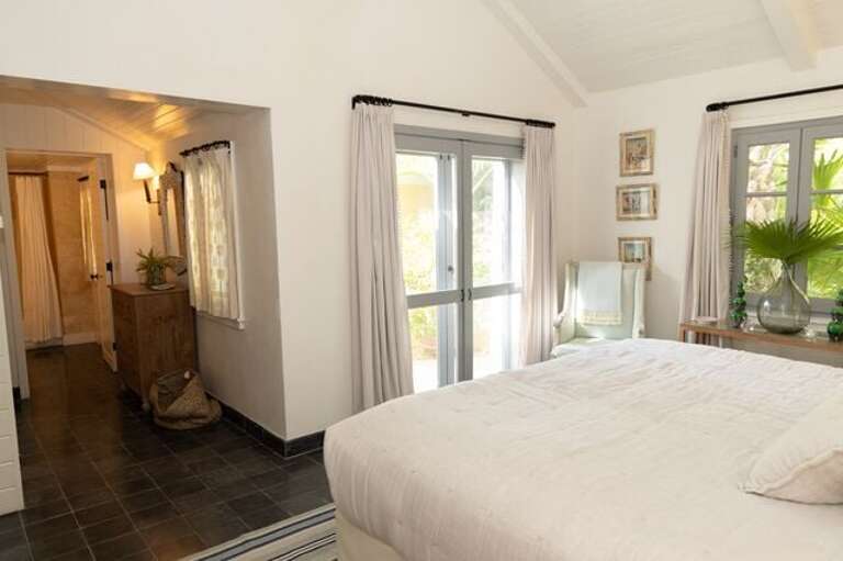 Main house first floor bedroom with king bed and en-suite bath.