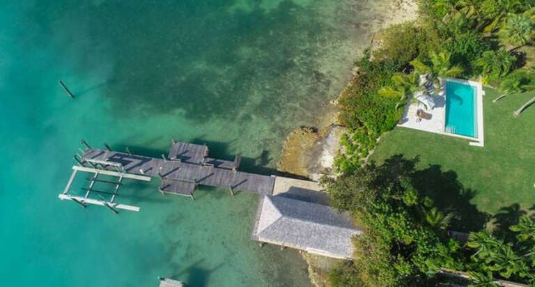 The private dock, pool, and dockside boathouse.