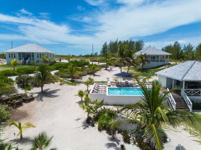 The Bohemia Two-Bedroom Villa shares this pool, pool house, and other amenities with the four bungalows visible in the background.