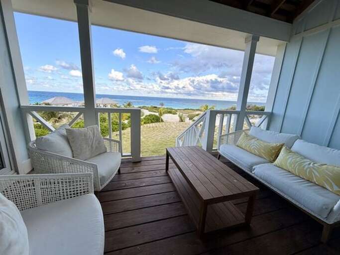 Covered porch with ocean view seating.
