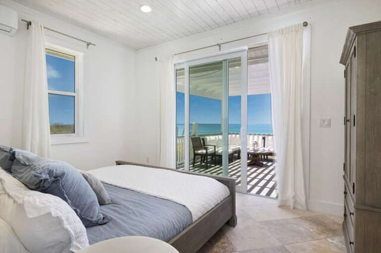 Main lodge bedroom with king bed and ocean view.