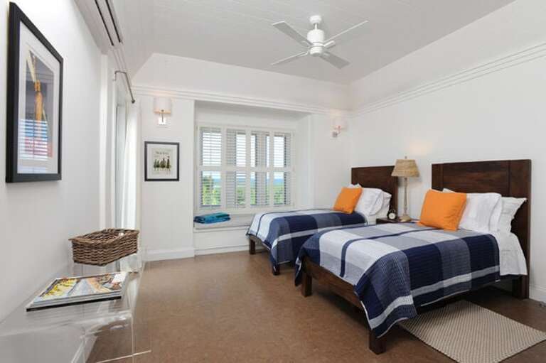 Typical condominium guest suite with Atlantic Ocean view, window seat, and en suite full bath.  The twin beds can convert to a king