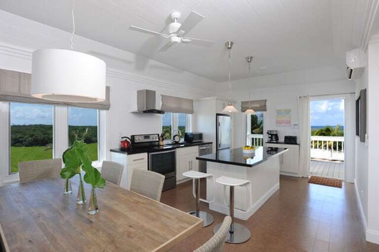 Typical condominium kitchen in black granite and stainless steel, with views of both oceans.
