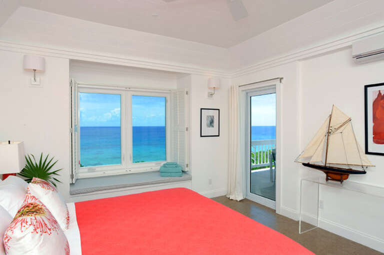Typical condominium master suite with balcony and 50-mile Caribbean view, facing the sunset.  Every bedroom has an en-suite full bath.