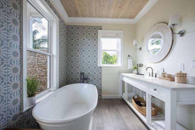 Downstairs master bath with stand-alone tub, walk-in shower, and private outdoor shower.