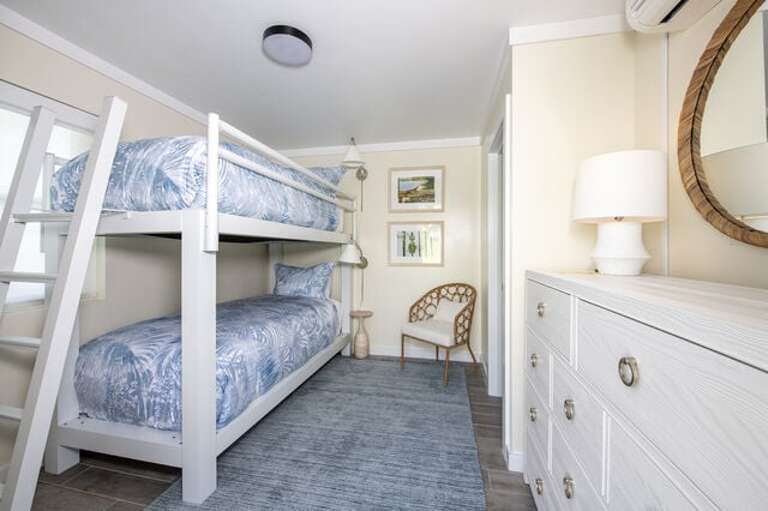 The estate's fifth bedroom with an XL twin bunk bed, suitable for staff or teens, is located beside the garage.  It has an en-suite full bath with a walk-in shower.