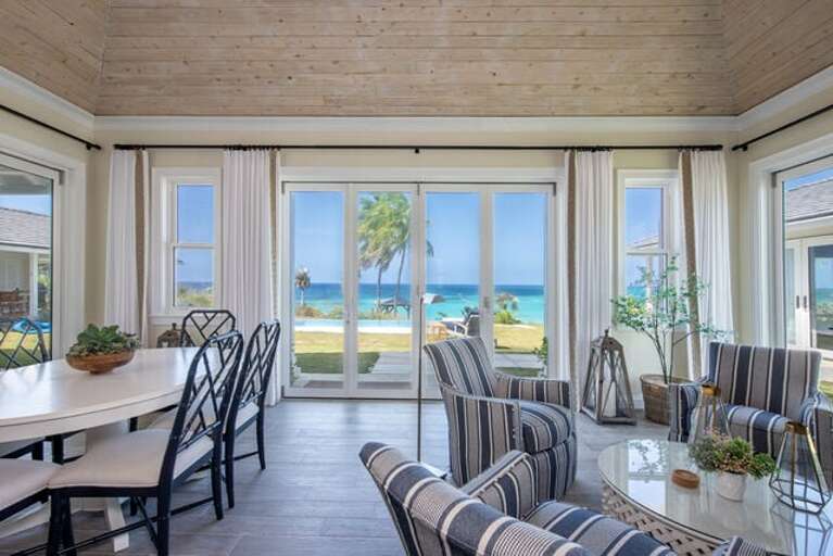 Great room with an ocean view!  Dining table at left can seat up to 10.  One of two sitting areas at right.