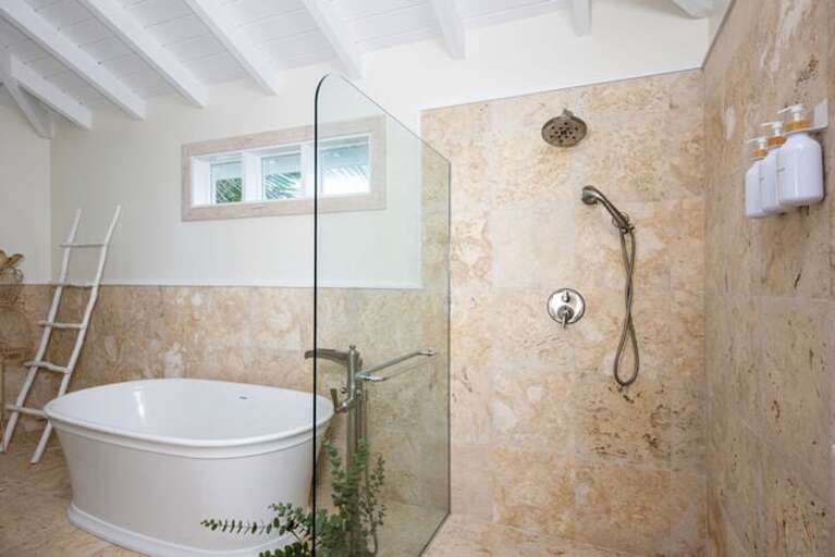 Guest cottage full bath with stand-alone tub and walk-in shower.