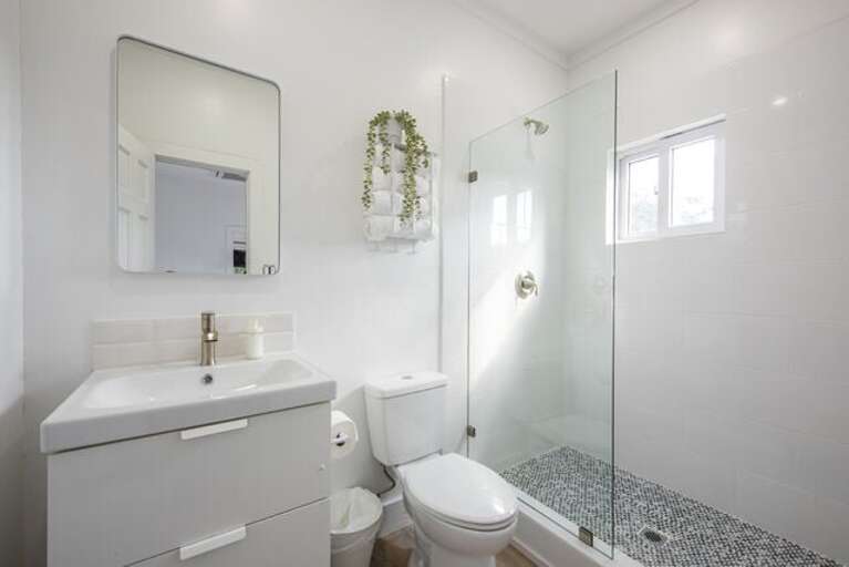 Bath with walk-in shower.