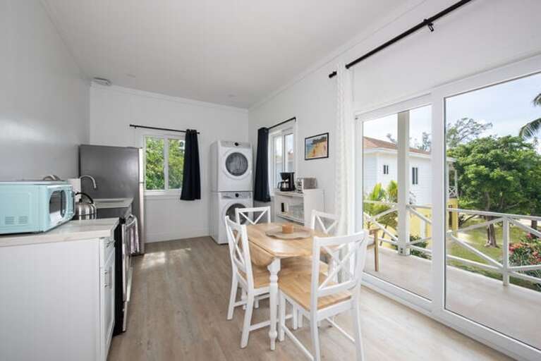 Fully equipped kitchen with laundry and dining area.