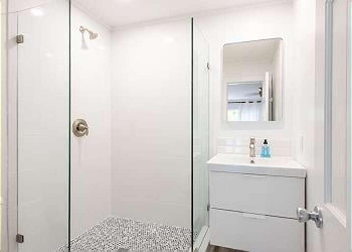 Bath with walk-in shower.