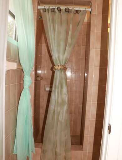 Bath with walk in shower.