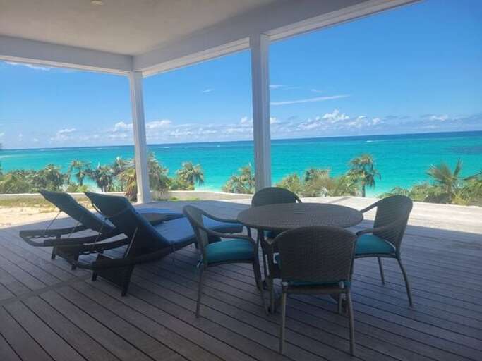 View from the deck overlooking the beach and ocean.  The beach is right behind the house accessed by a short flight of stairs.