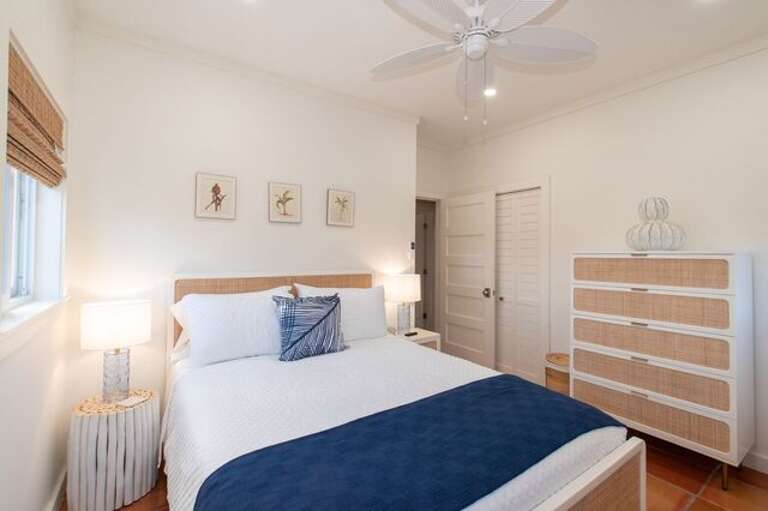 The second bedroom is furnished with a queen-sized bed, a wall-mounted Smart TV, and a spacious closet for all your belongings.