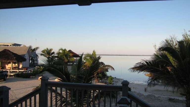 Sand Dollar Cottage view from deck.  Please note that while you CAN swim and snorkel behind the house, the water there is a bay, not a beach.