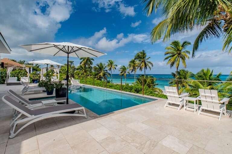 Beachfront pool and pool deck.