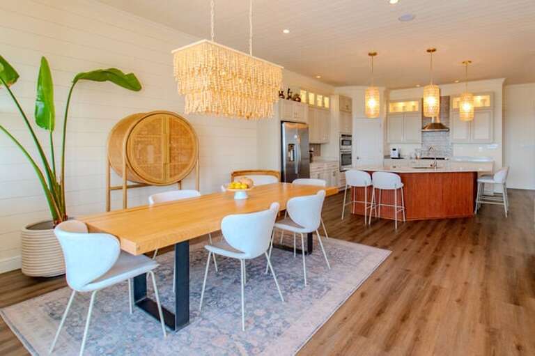 Dining area looking into kitchen with additional bar seating.