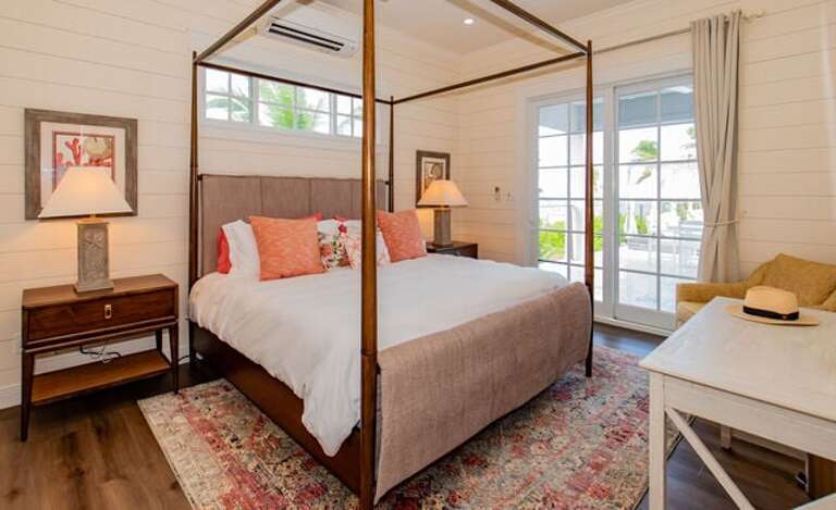 Guest bedroom with king bed, ocean view, and en-suite bath.