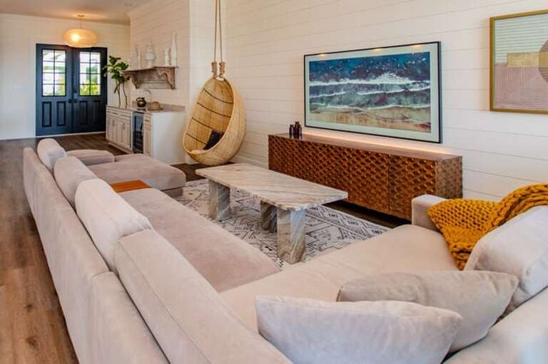 Throughout the home the shiplap covered walls are adorned by beautiful original art work.